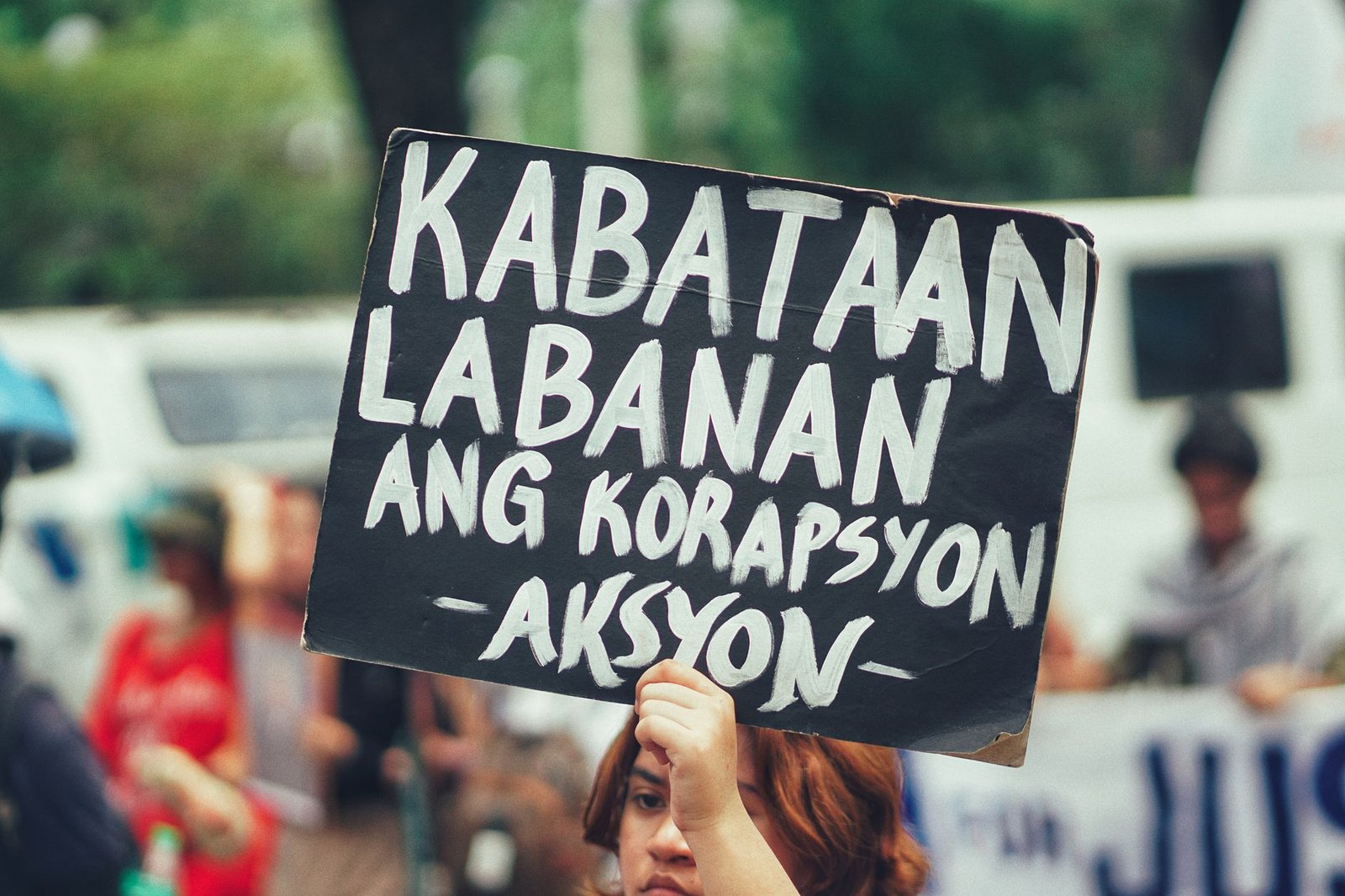 protest sign against corruption in street rally
